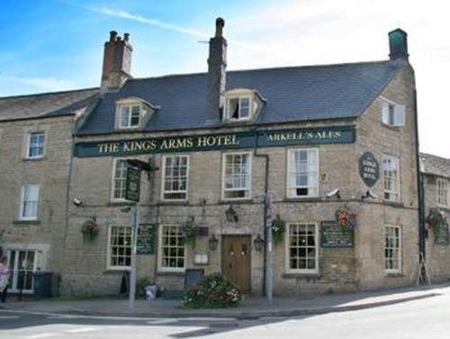 a large brick building with a sign that reads the kings arms hotel at The Kings Arms Hotel in Chipping Norton