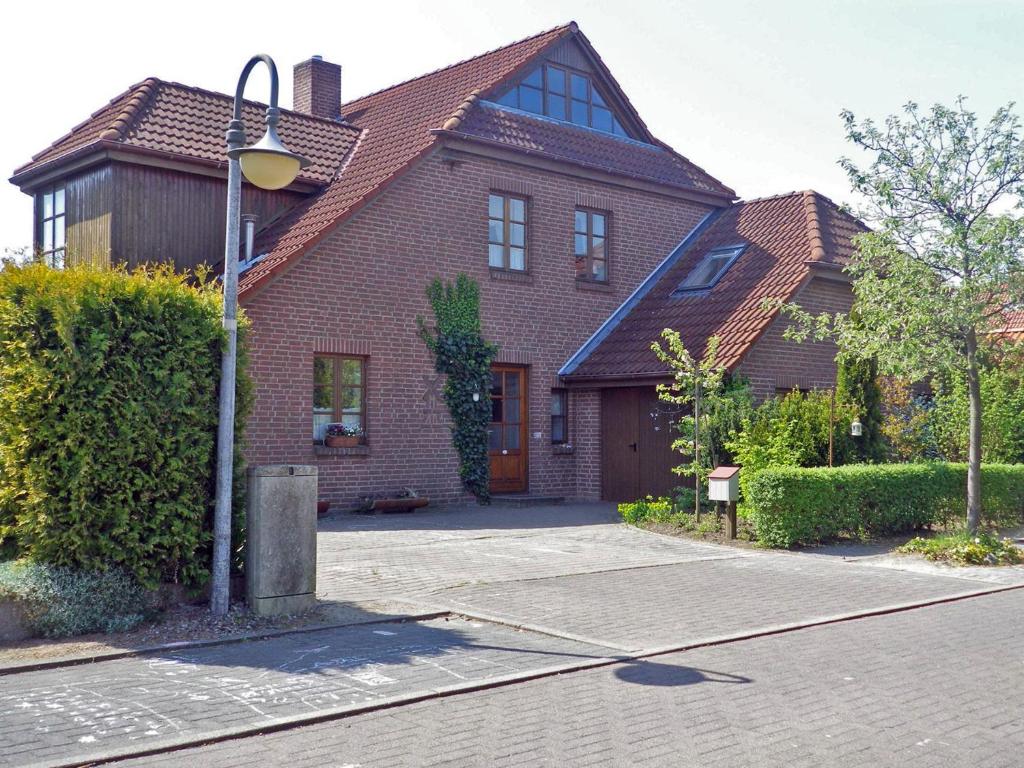 a brick house with a street light in front of it at Ferienwohnung "Luv" Grube Ostsee in Grube