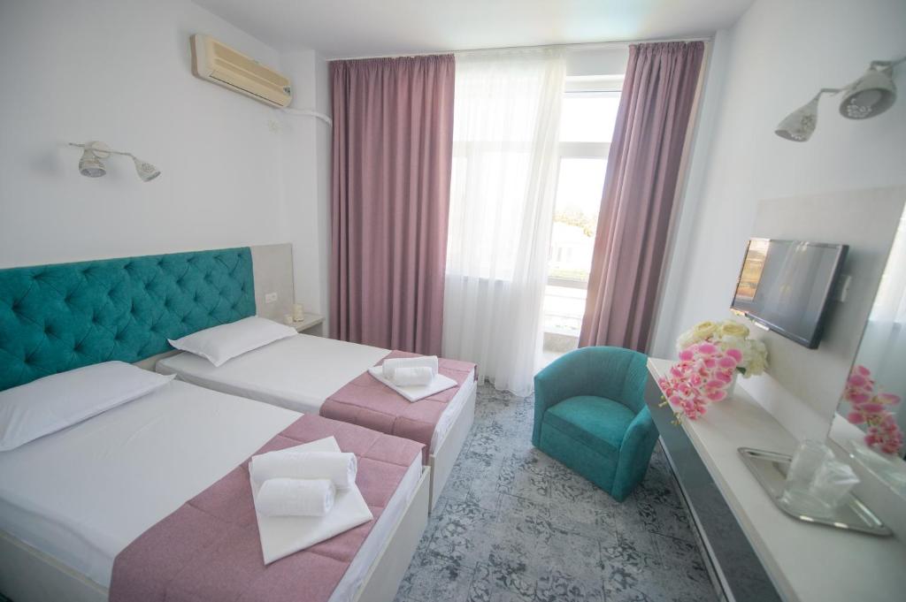 Postel nebo postele na pokoji v ubytování Hotel Olguta