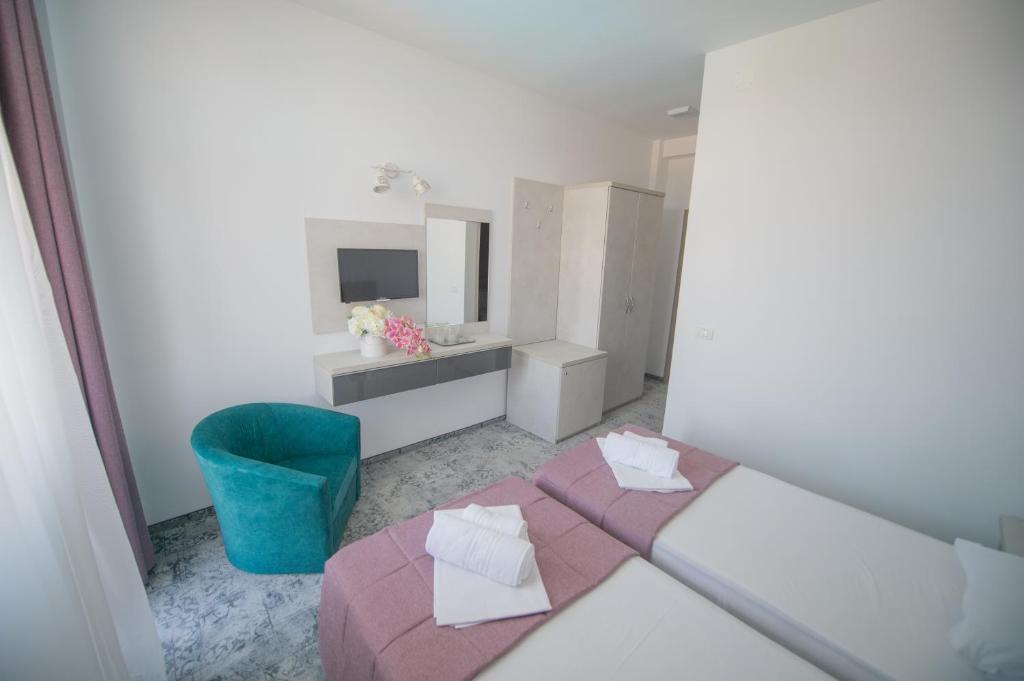 Postel nebo postele na pokoji v ubytování Hotel Olguta
