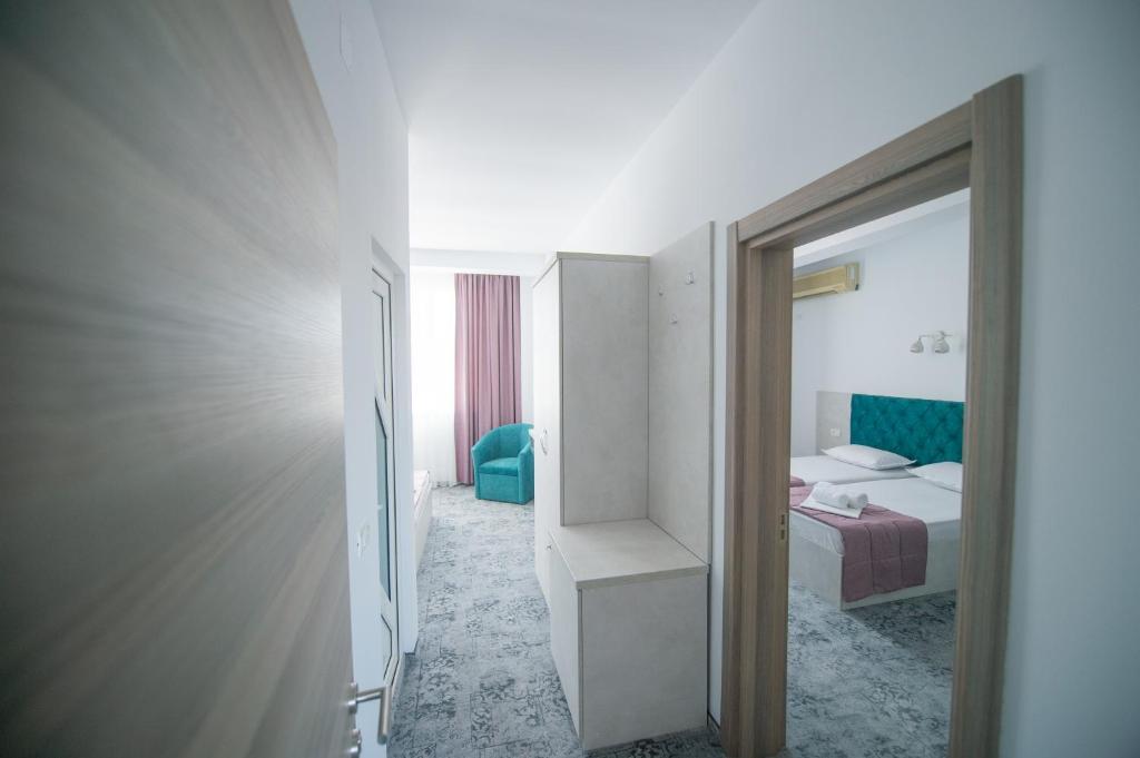 Postel nebo postele na pokoji v ubytování Hotel Olguta