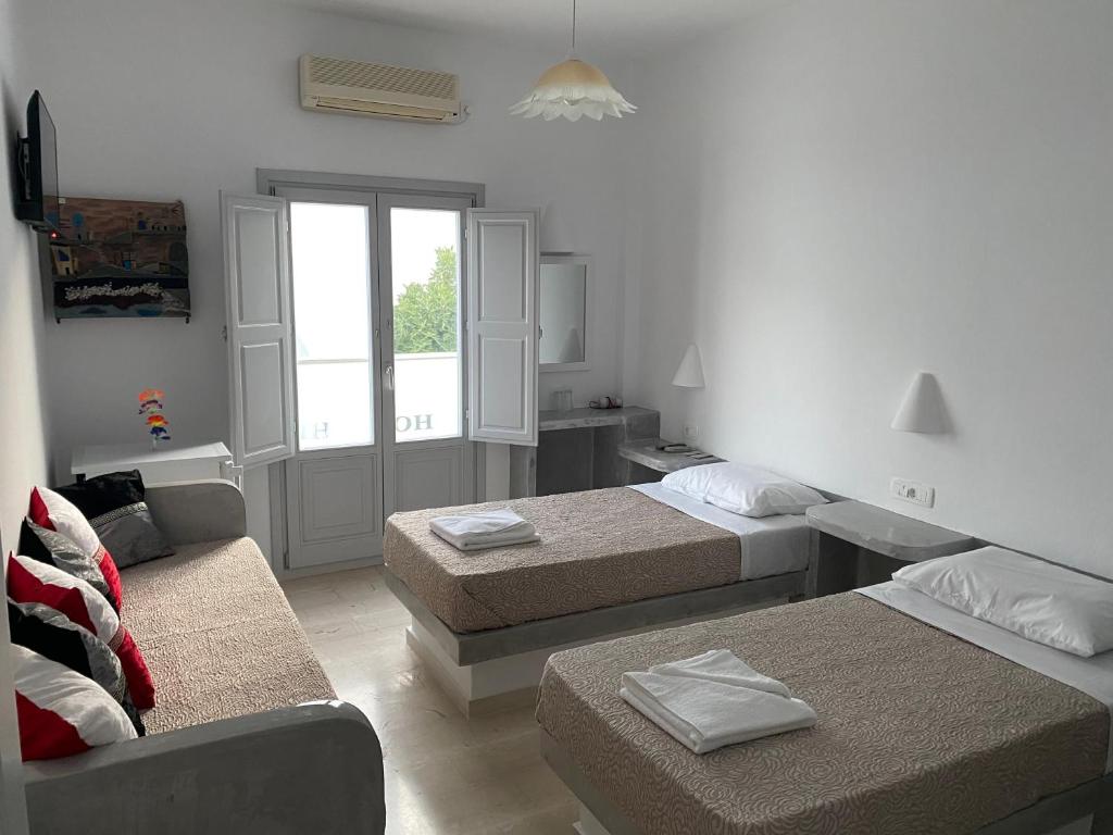 Postel nebo postele na pokoji v ubytování Hotel Hellas