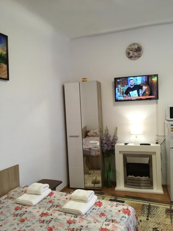 a bedroom with two beds and a mirror and a tv at House Centrul Istoric ll in Sibiu