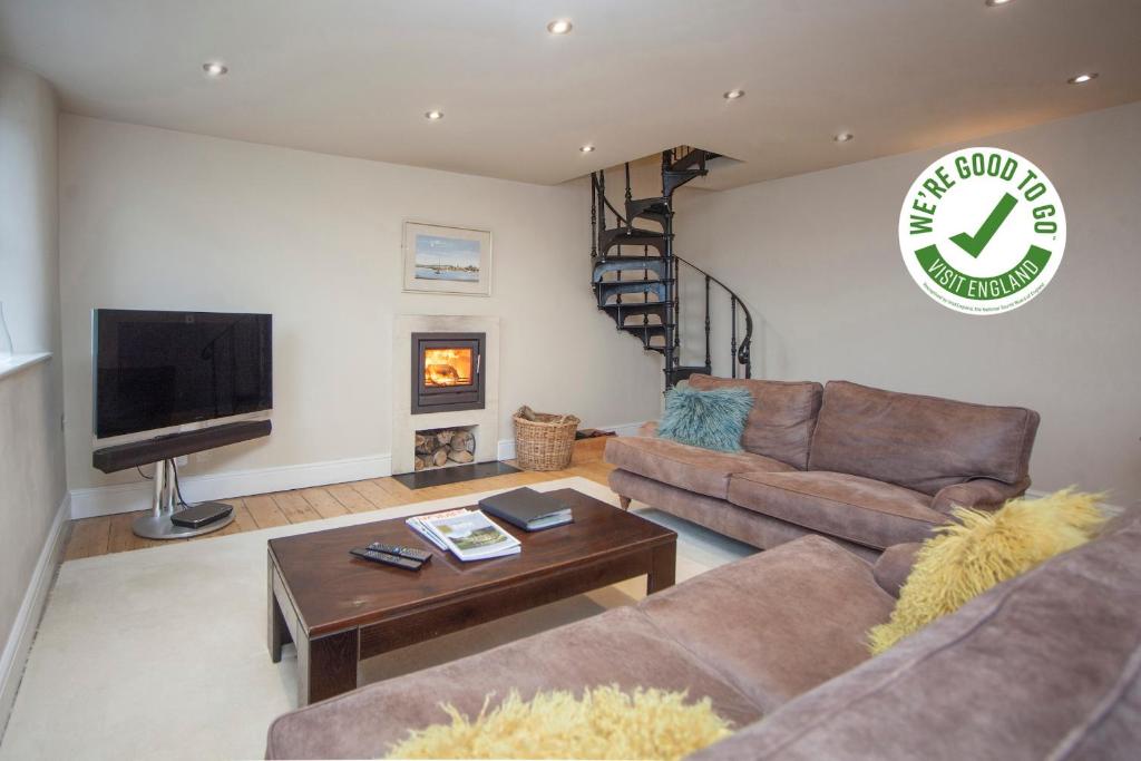 a living room with two couches and a tv at Victorian Annexe - Bath in Bath