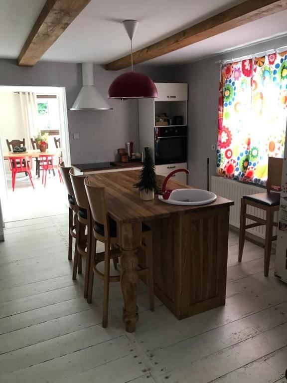 a kitchen with a wooden table and some chairs at Siedlisko U Źródeł in Skierbieszów