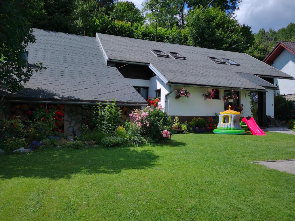 a house with a yard with a playground at Privát Zvonček in Terchová