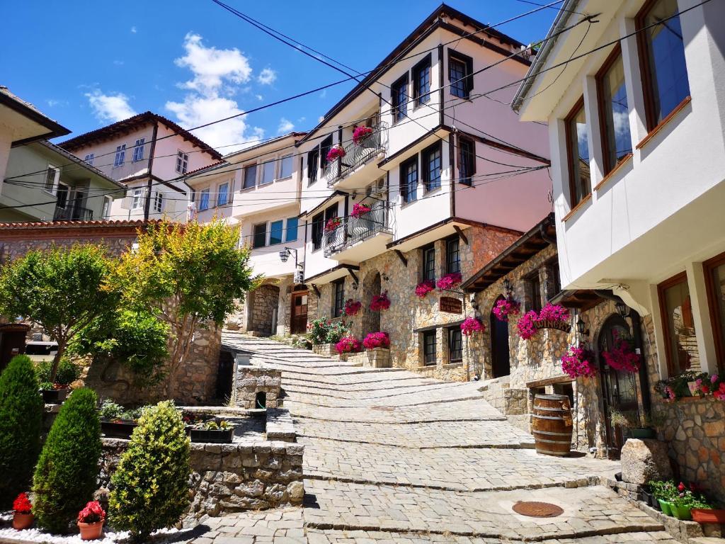 a cobblestone street in a town with buildings at Villa & Winery Mal Sveti Kliment in Ohrid