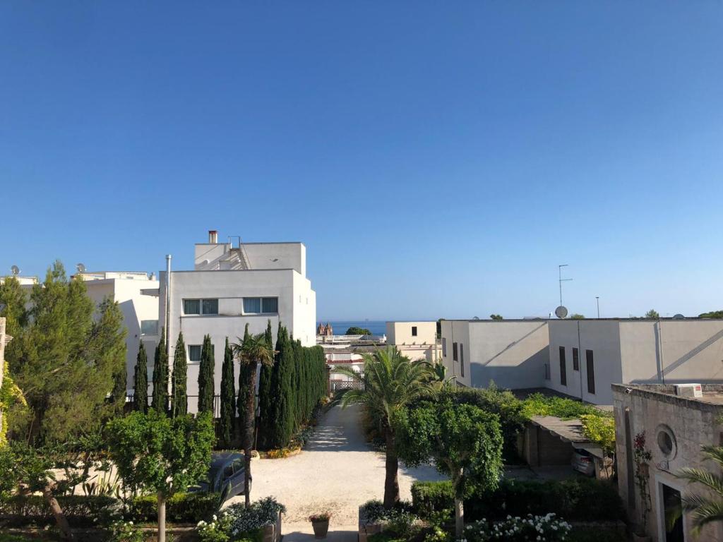 a view of a city with palm trees and buildings at Villa Romasi in Leuca