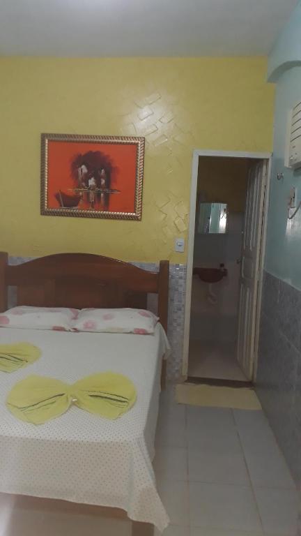 a bedroom with a bed with a bow on it at Pousada Casa Branca in Salinópolis