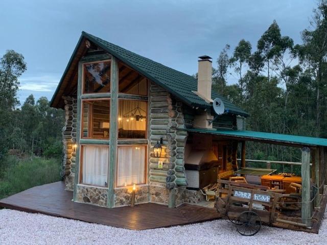 a small log cabin with a large window at Damiro in Piriápolis