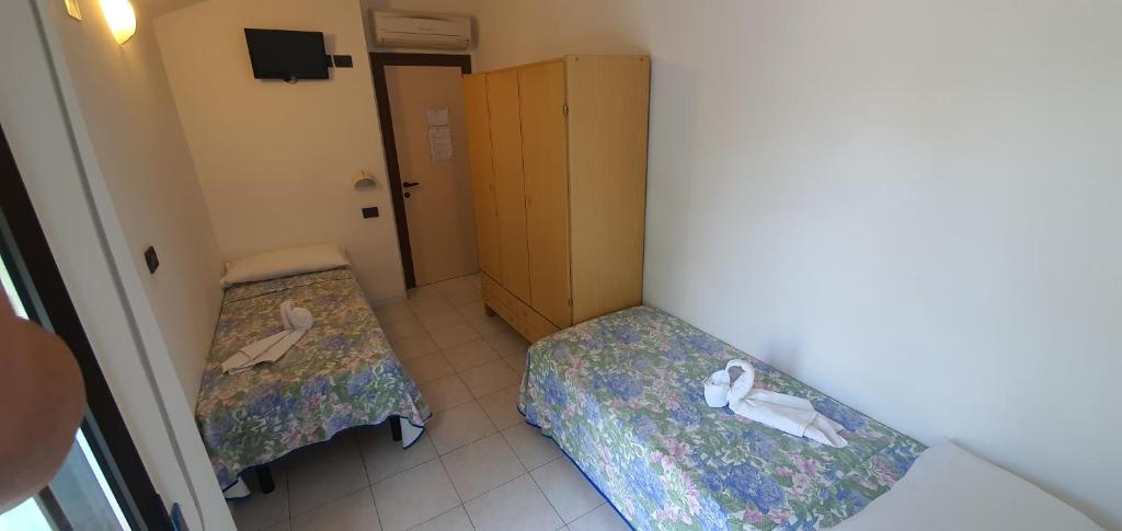 Postel nebo postele na pokoji v ubytování Hotel Vela Azzurra