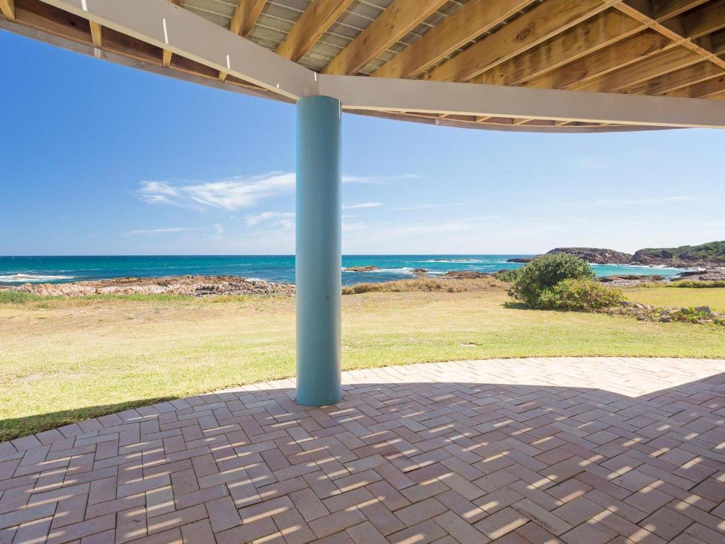 a view of the ocean from the porch of a house at The Whale Watcher waterfront unit with stunning views level access in Anna Bay