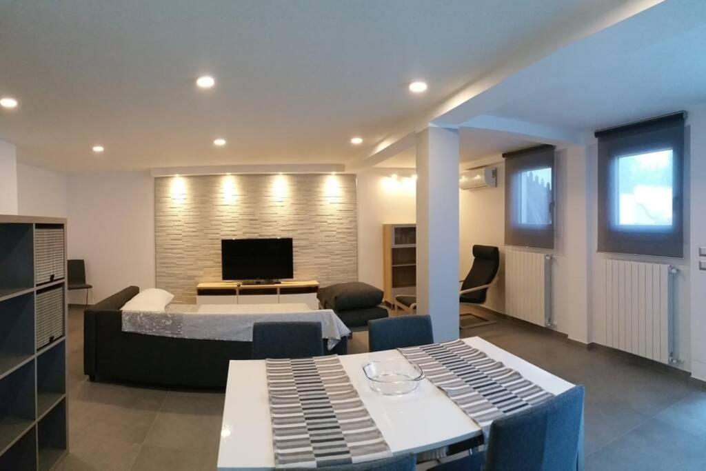 a living room with a bed and a television at Via Mare in Ginosa Marina