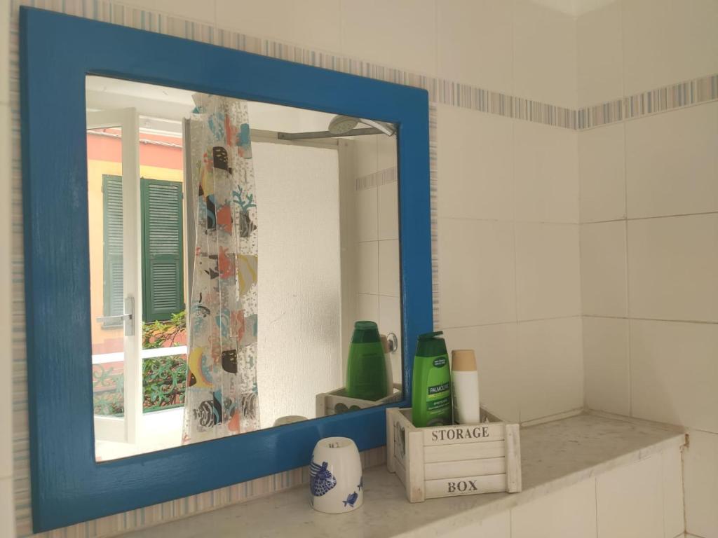 a mirror sitting on a shelf in a bathroom at Chez Tamara with private parking and air conditioned in Monterosso al Mare