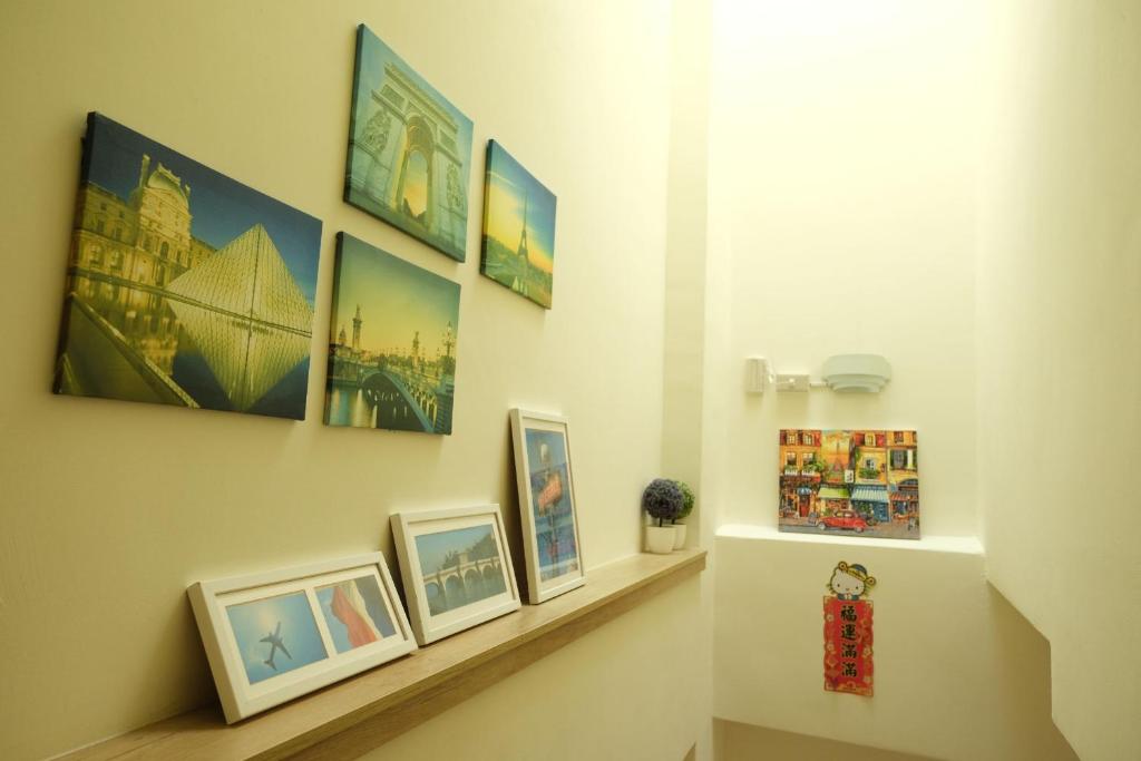 a hallway with a shelf with pictures on the wall at Bonjour, Paris in Taitung City