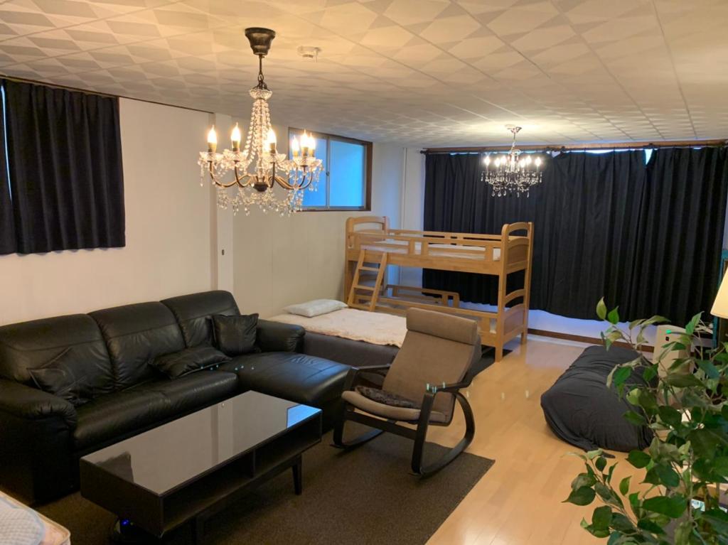 a living room with a couch and a bunk bed at hanare in Shingū