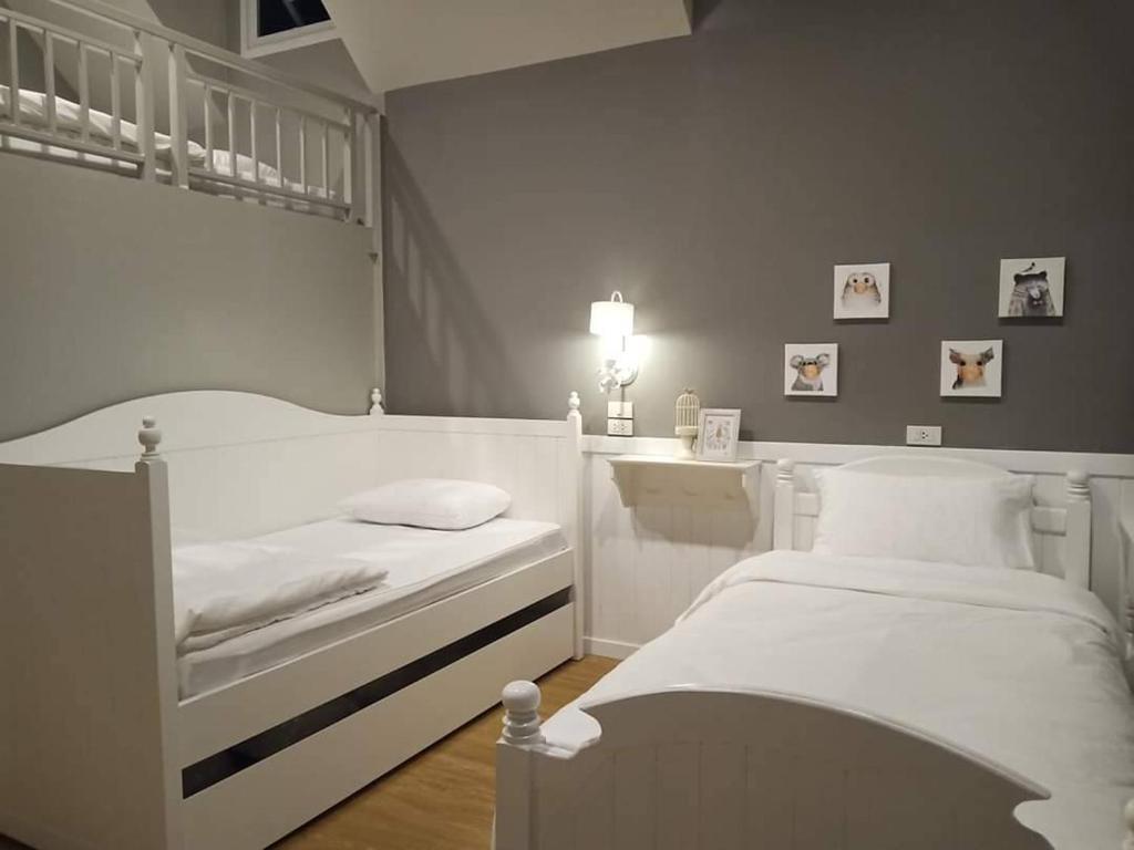 Postel nebo postele na pokoji v ubytování Baan JaoKorKluay บ้านเจ้ากอกล้วย