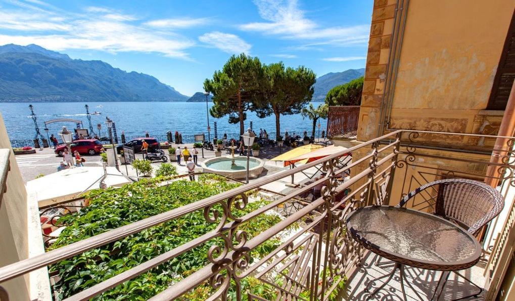 
a balcony overlooking a beach with a view of the ocean at Hotel Garni Corona in Menaggio
