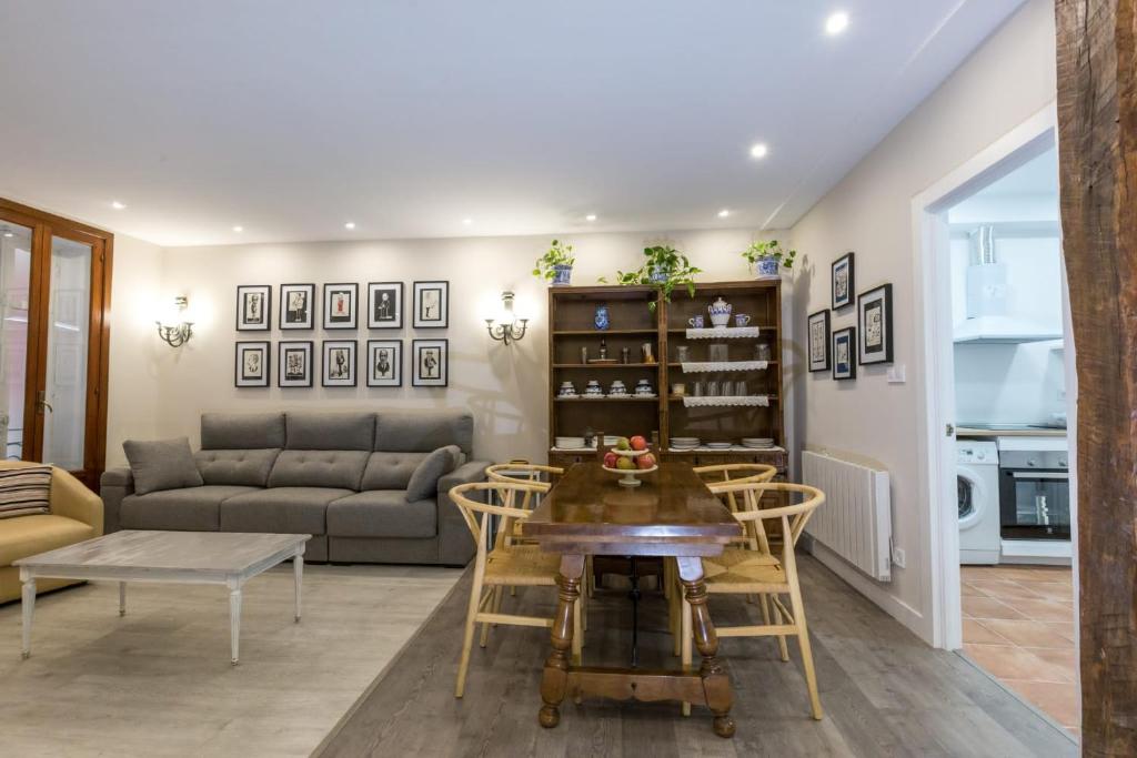 a living room with a couch and a table and chairs at Espacioso Apartamento a estrenar!! Casco Viejo in Bilbao