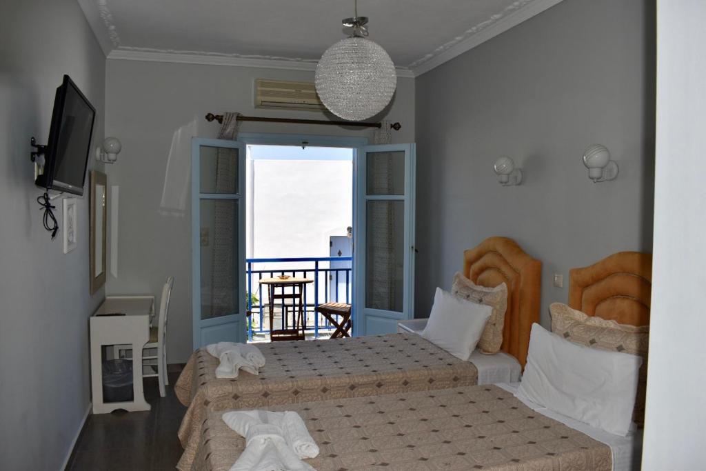 Postel nebo postele na pokoji v ubytování Minoa Hotel