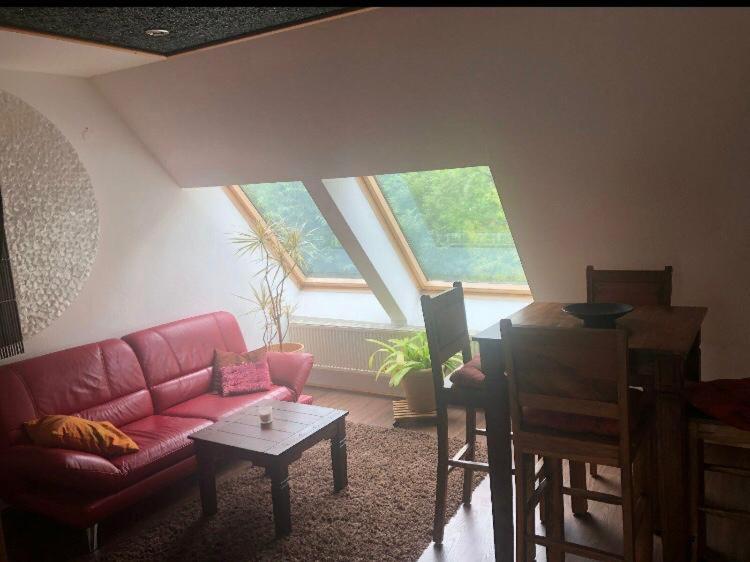 a living room with a red couch and a table at Piraten Oase in Tribohm