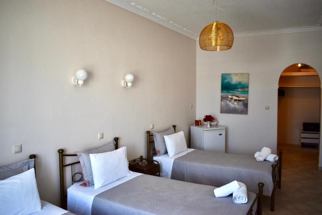 Postel nebo postele na pokoji v ubytování Minoa Hotel