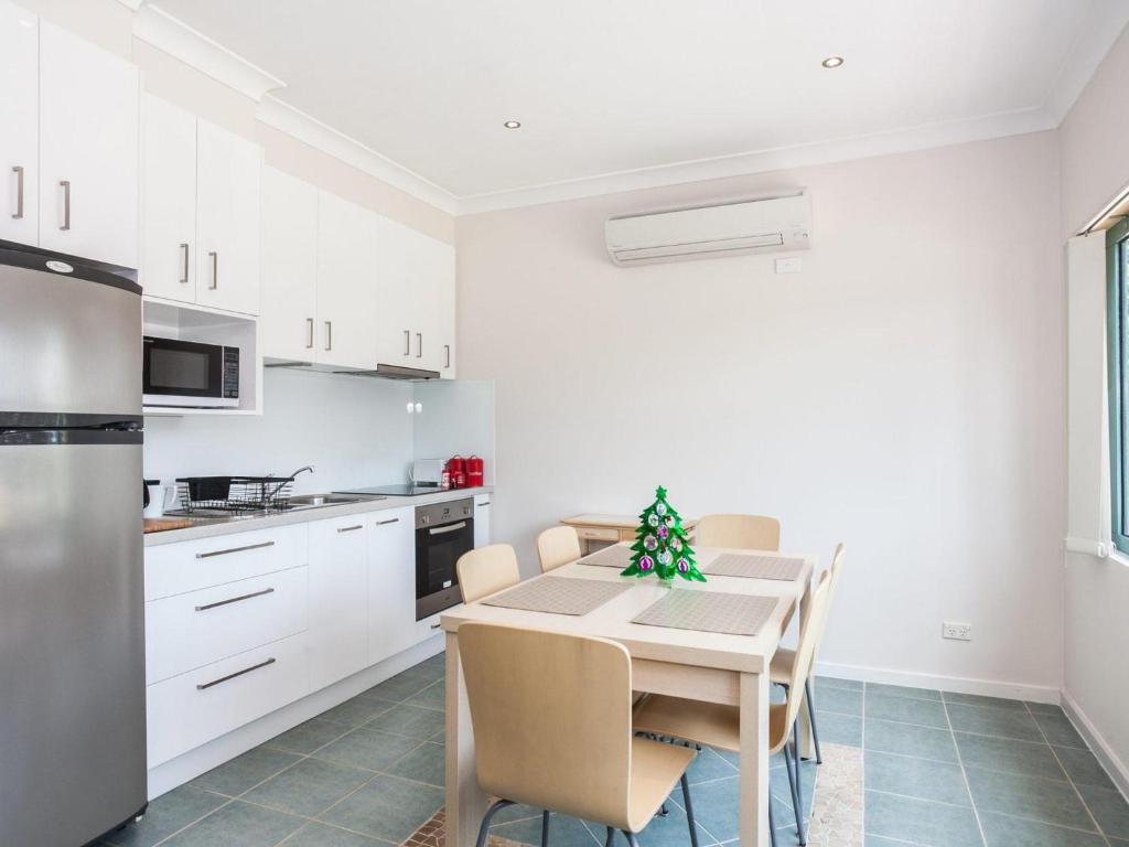 a kitchen with a table with a christmas tree on it at Anglesea River Apartment On Noble in Anglesea