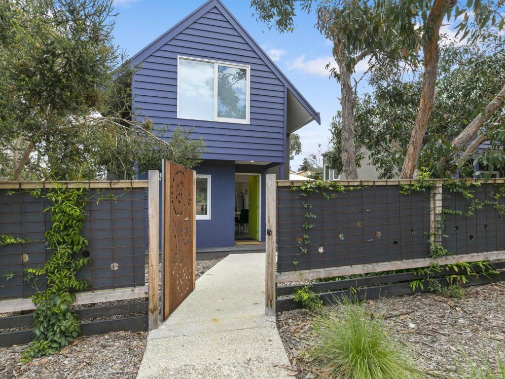 a blue house with a fence in front of it at Liokai in Anglesea