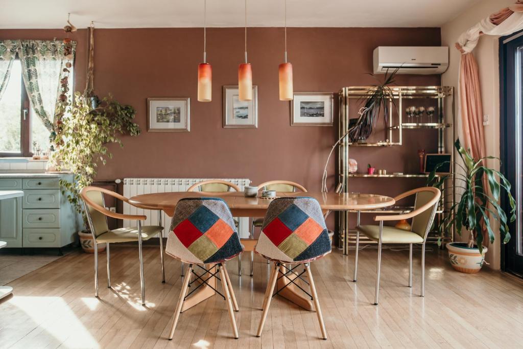 a dining room with a wooden table and chairs at Apartments Ivana in Dramalj
