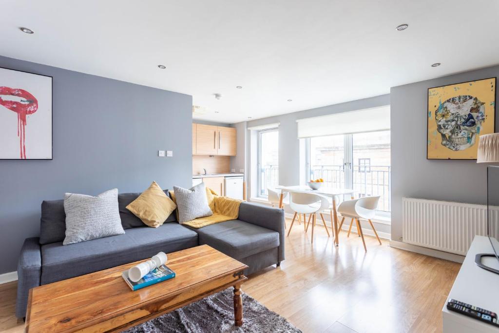 a living room with a couch and a table at Merchant City Modern 1 Bed Executive Flat in Glasgow