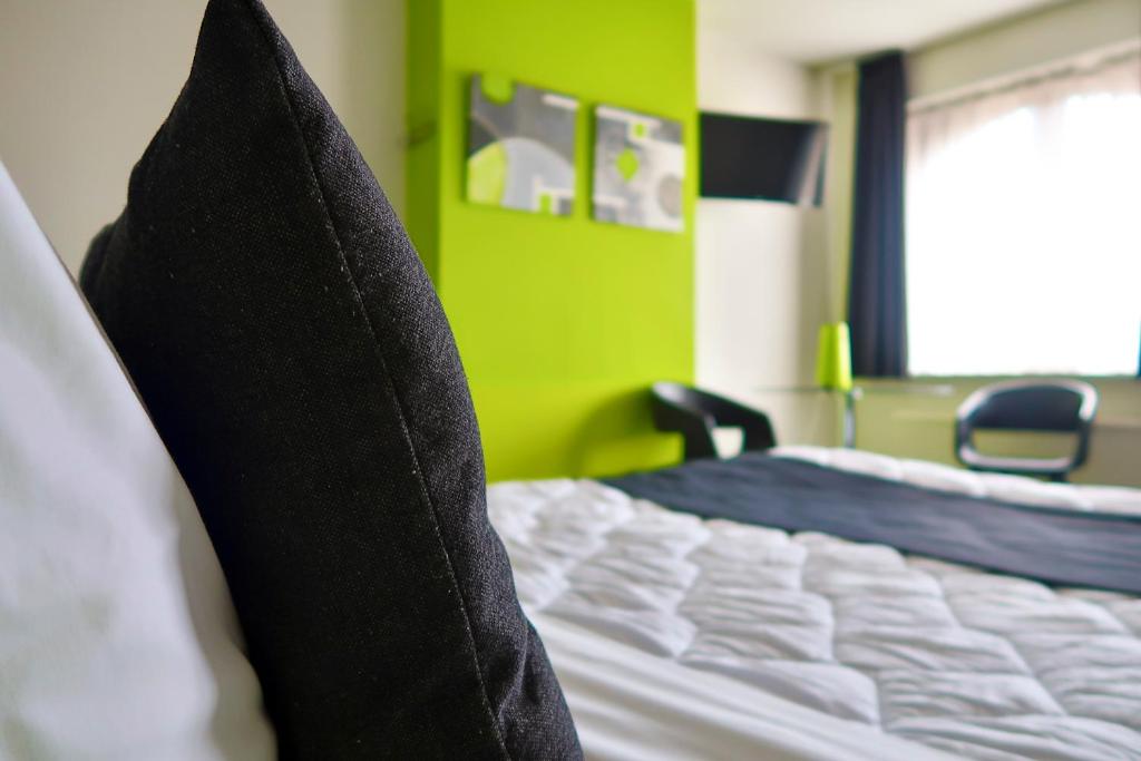 Postel nebo postele na pokoji v ubytování Hotel Adoma