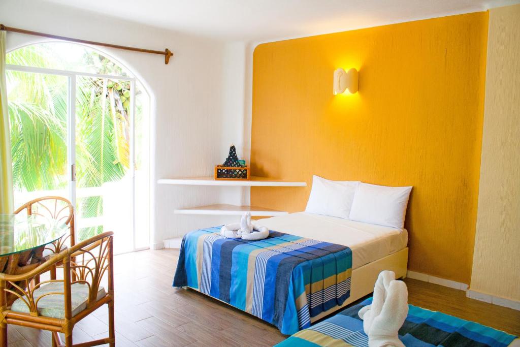 Una cama o camas en una habitación de Hotel Bahia Huatulco
