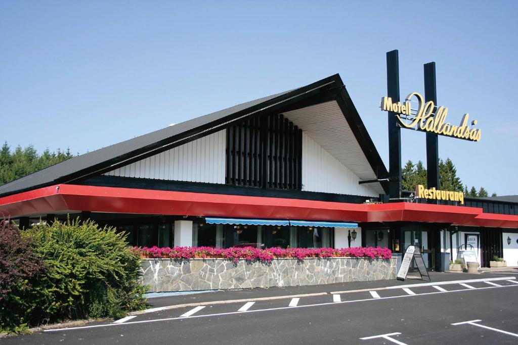 a building with a sign on the side of it at Rasta Hallandsåsen in Båstad