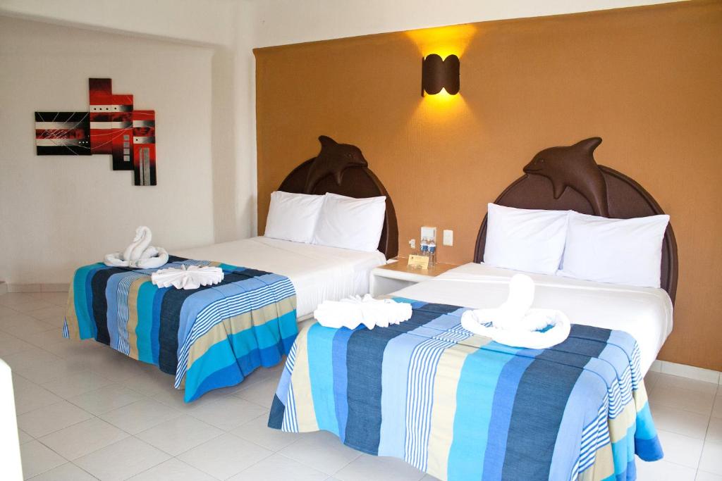 Una cama o camas en una habitación de Hotel Bahia Huatulco