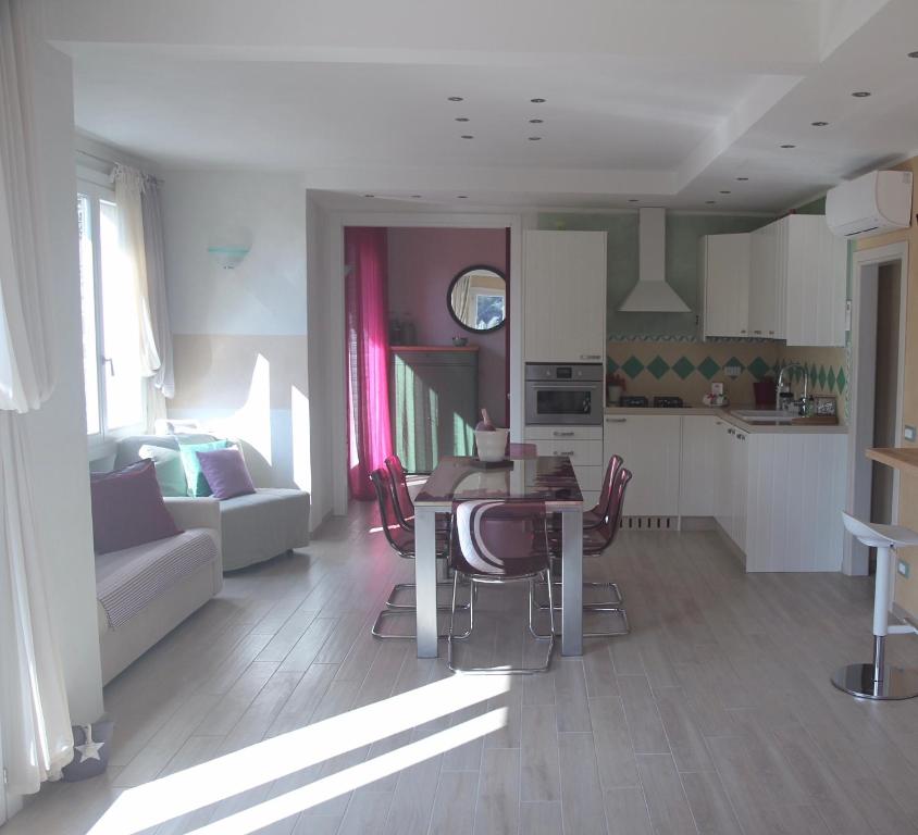 a kitchen and living room with a table and chairs at BougainvilleaP in Monterosso al Mare