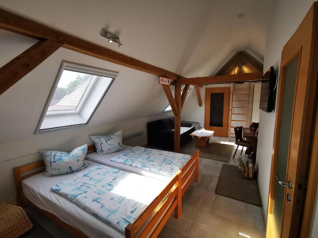 a bedroom with two beds and a window at Loft auf dem Land in Ludwigslust