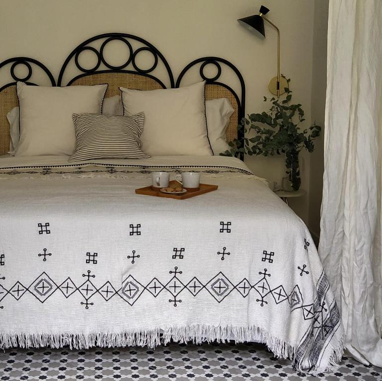 a bed with a black and white comforter with two candles on it at Botteghelle14 suites in Salerno