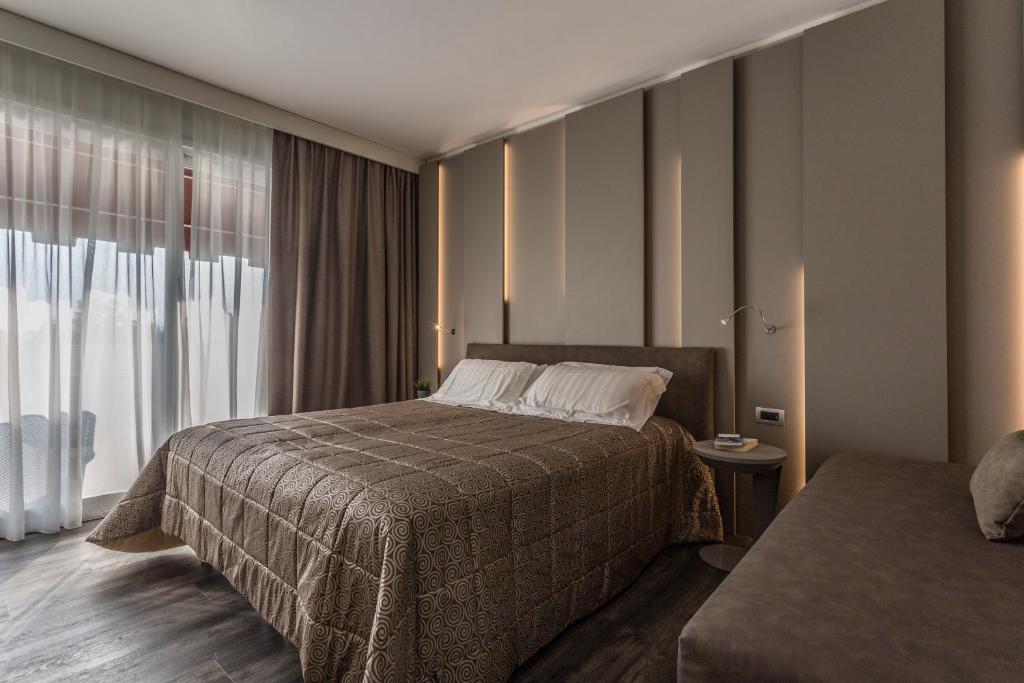 Een bed of bedden in een kamer bij Hotel Giulietta Romeo
