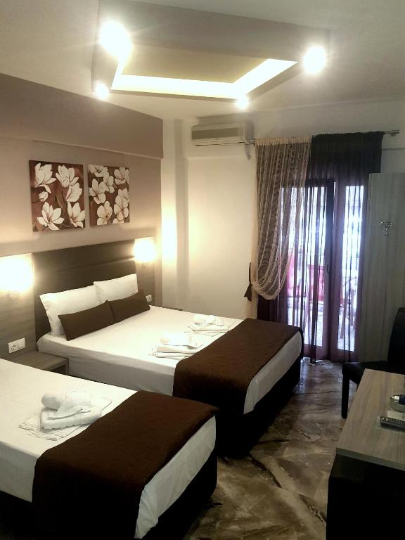Posteľ alebo postele v izbe v ubytovaní Hotel Kostas