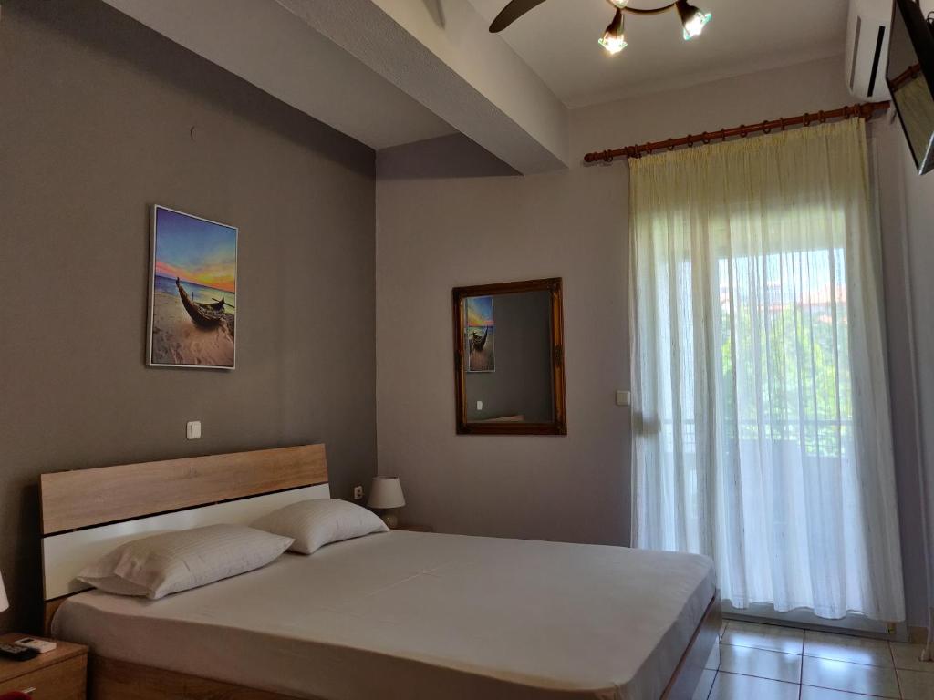 A bed or beds in a room at Methexis Apartment