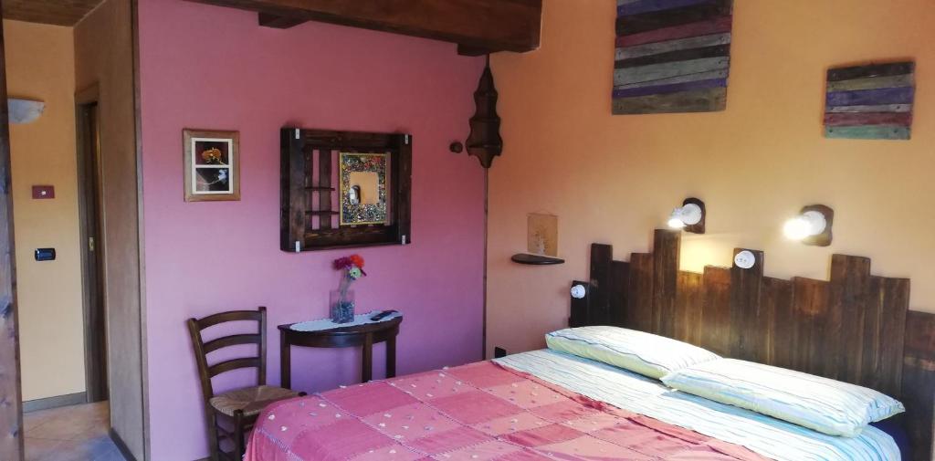 a bedroom with a bed and a table and a mirror at B&B Caselunghe in Camerino