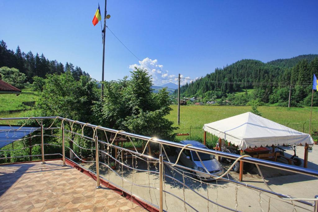 a boat with a white tent on a patio at Pensiunea Paradiso in Poiana Teiului