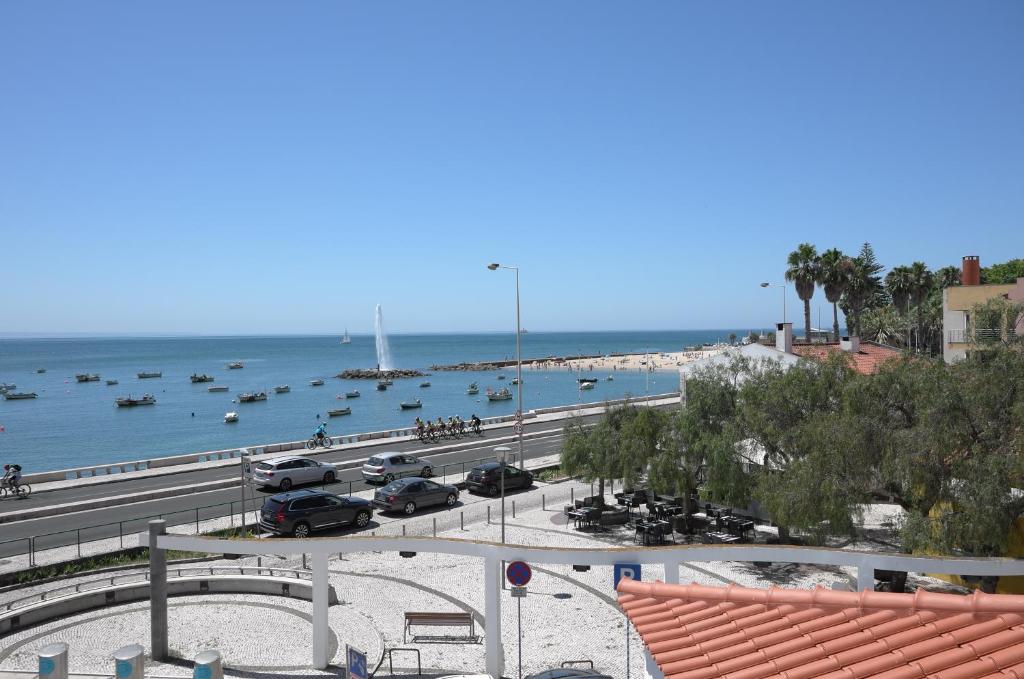 a view of a beach with boats in the water at Ocean View double Suite in Paço de Arcos
