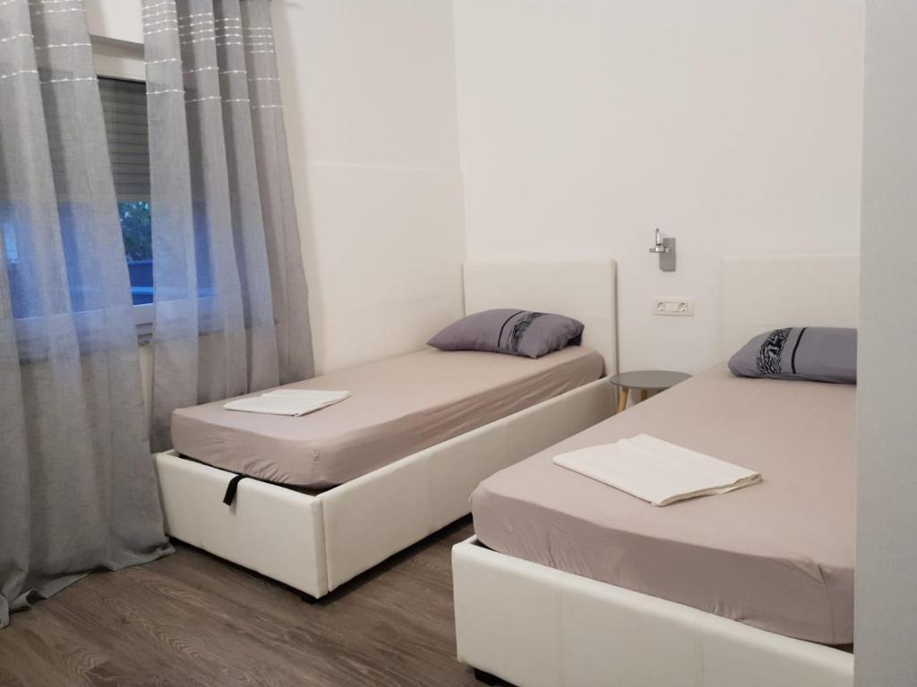 Posteľ alebo postele v izbe v ubytovaní Apartman Bitunjac