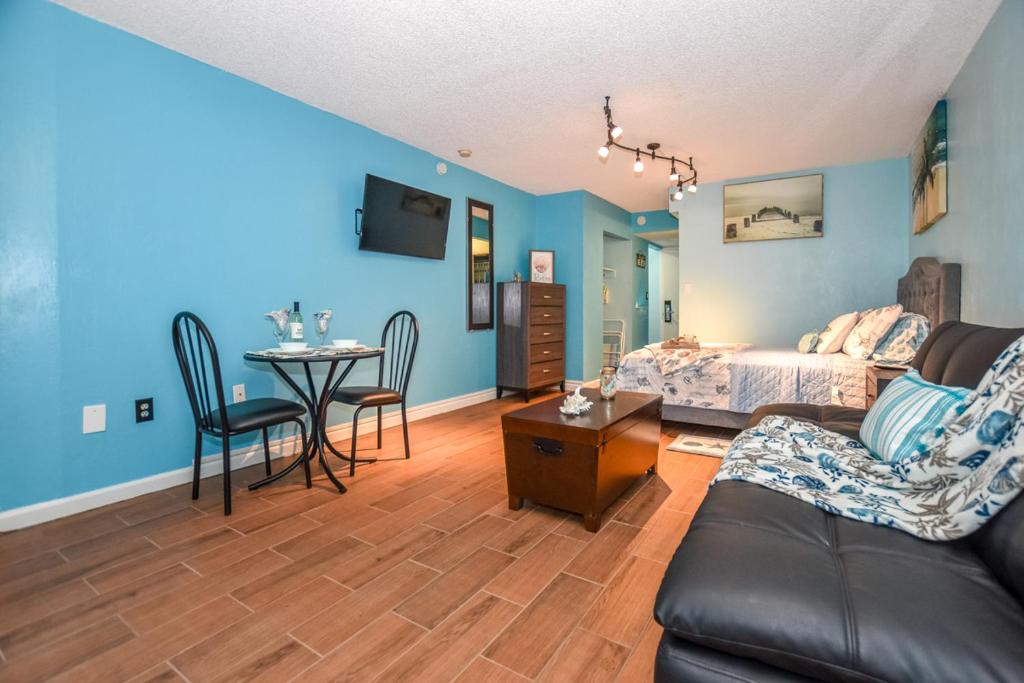 a living room with a couch and a table at Daytona Condo with Beautiful Ocean and City View in Daytona Beach