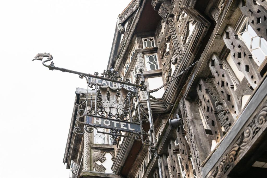 a hotel sign on the side of a building at The Feathers Hotel in Ludlow