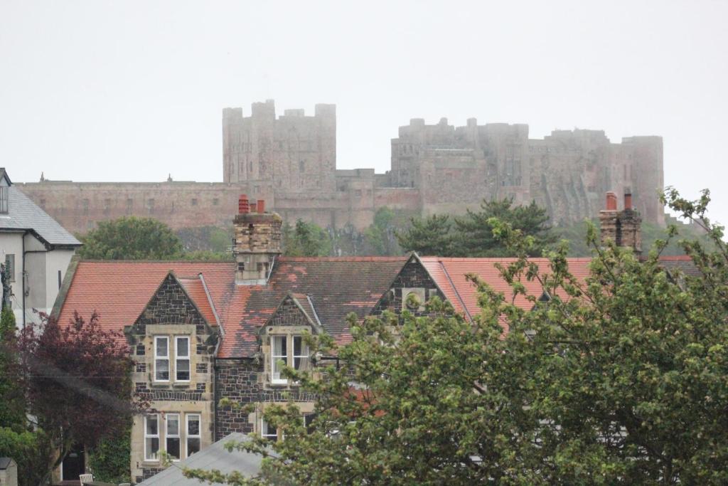 a group of houses with a city in the background at The Sunningdale in Bamburgh