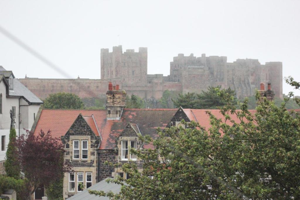a city with a castle in the background at The Sunningdale in Bamburgh