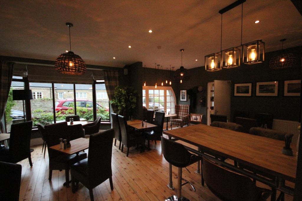 a restaurant with tables and chairs and a dining room at The Sunningdale in Bamburgh