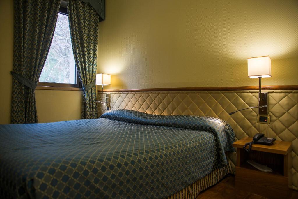 Postel nebo postele na pokoji v ubytování Hotel Giubileo
